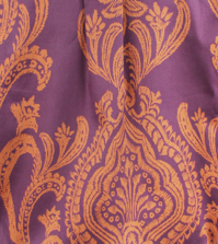Close-up of a purple fabric with gold intricate patterns