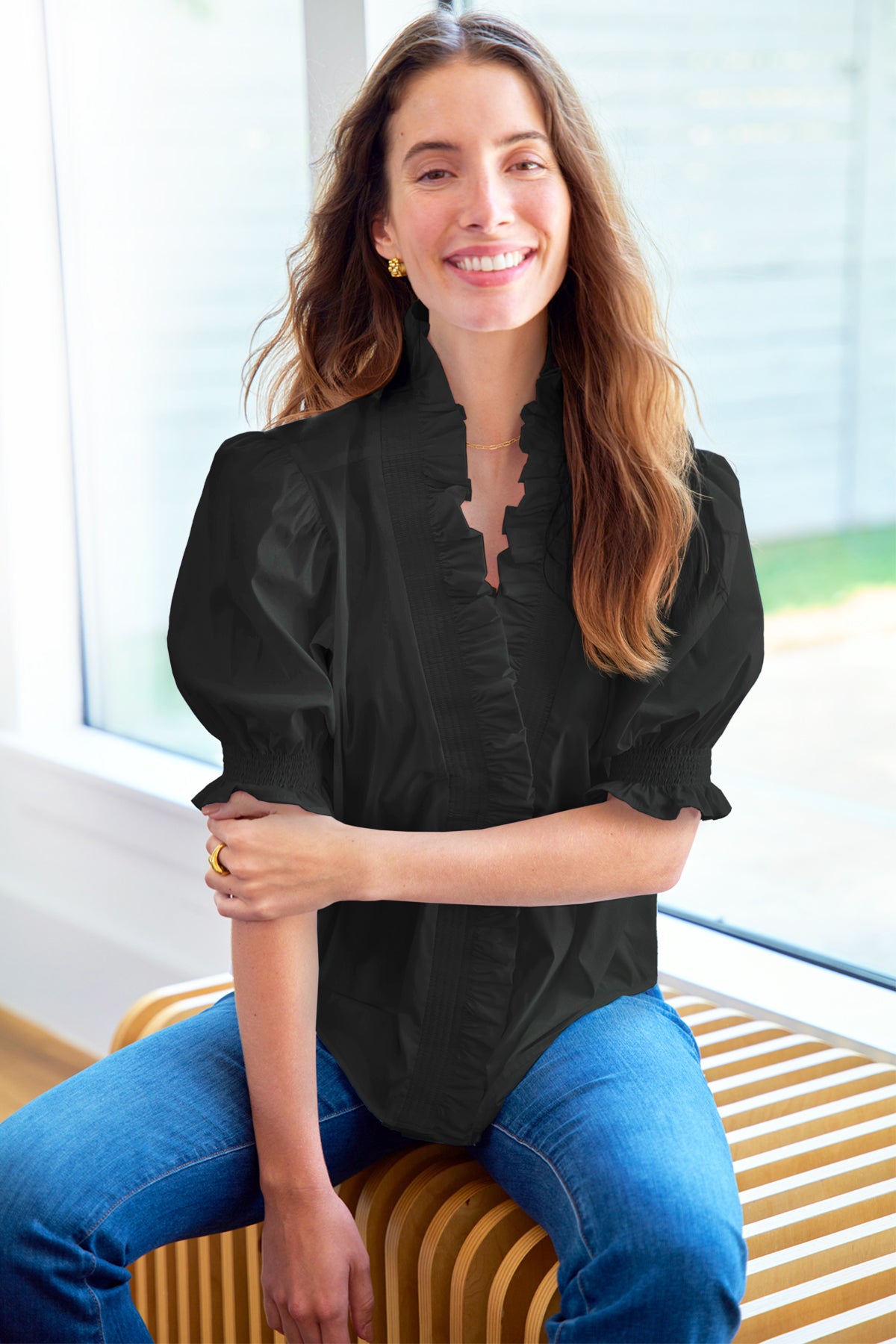 a model front view of the Finley Cici blouse in black taffeta with a v-neckline, relaxed contour, and elbow puff sleeves.