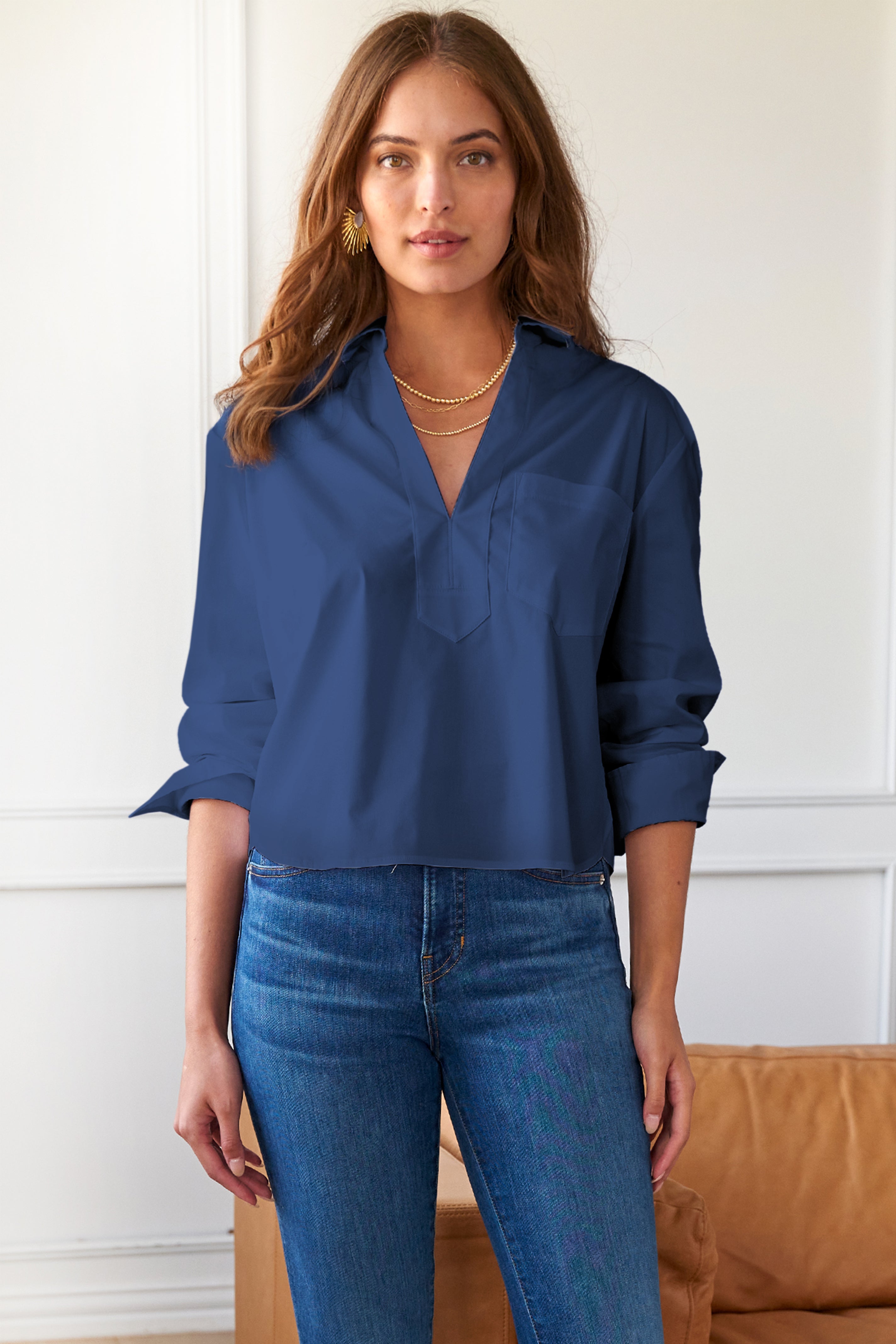 Model wears Finley Joni navy poplin popover blouse with V neckline and chest pocket. Boxy fit.