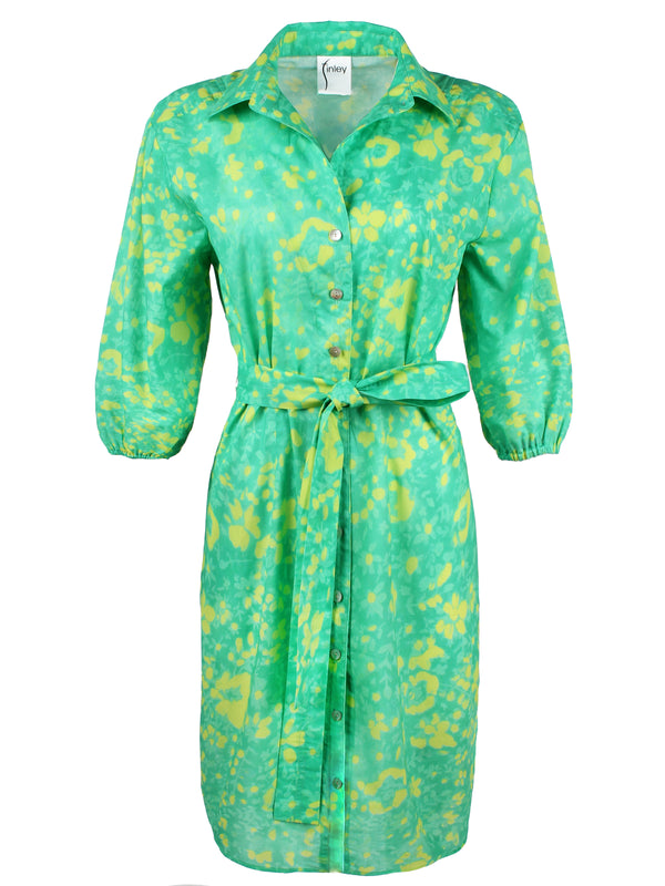 A front view of the Finley Natalie shirt dress, a tie-front shirt dress with a semi-fitted shape and a bright green and yellow floral print.