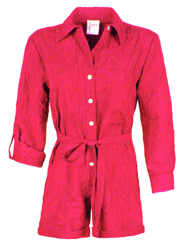 A front view of the Finley Romper, a raspberry pink jacquard one-piece button down romper with a tie front and barrel cuffs.