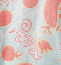 Close-up of a fabric with pink floral patterns on a light blue background