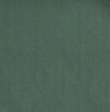 A close-up of a solid dark green textured material, likely fabric or leather.
