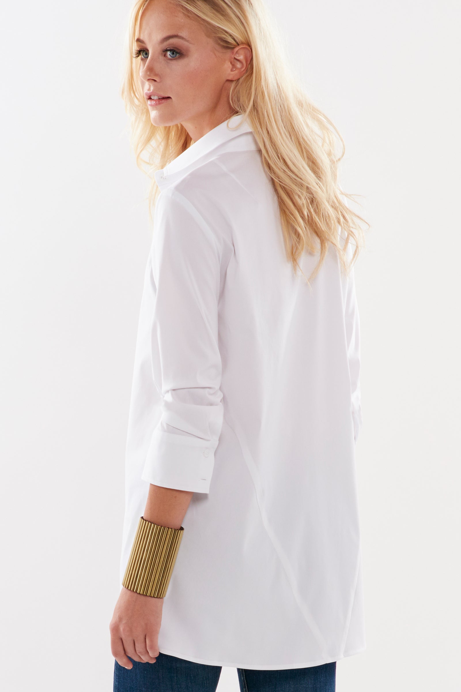 A front view of the trapeze top, a white 3/4 sleeve button-down casual blouse with an A-line shape and relaxed fit.