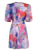 The Finley Lilly dress, a cotton tie front midi wrap dress with blouson sleeves and a tropical multicolor print.
