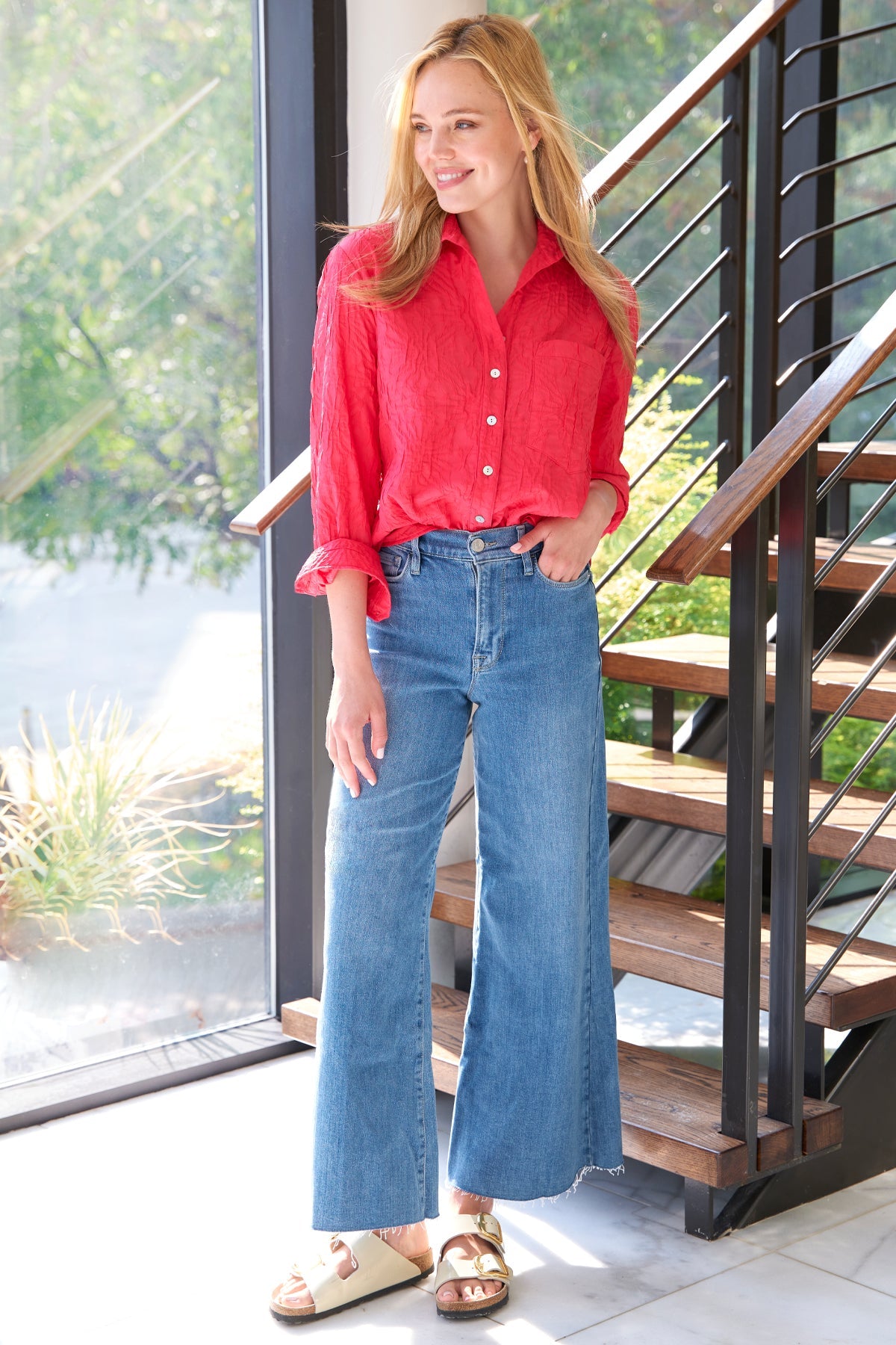 A supermodel wearing the Finley Andie blouse, a cotton button down raspberry pink blouse with a relaxed contour and barrel cuffs