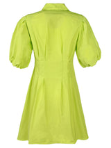 A rear view of the Finley Avery, a pleated neon green mini shirt dress with a tucked waist and puff sleeves.