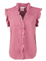 A front view of the Finley Byrdee blouse, a sleeveless popover pink seersucker designer blouse with ruffle detailing on the sleeves and collar.