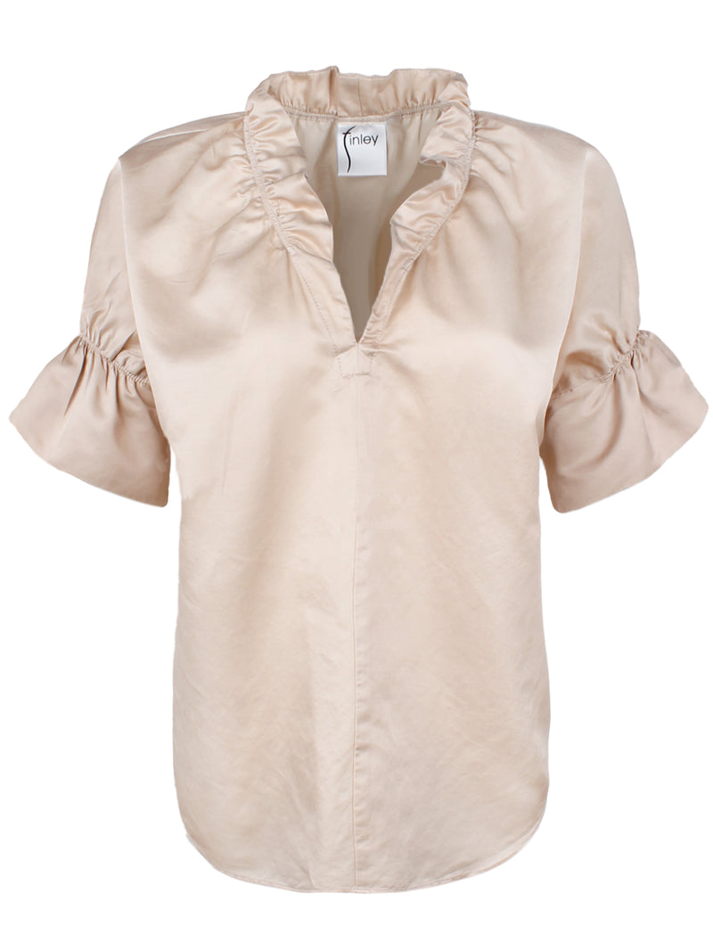 A front view of the Finley Crosby blouse, a short sleeve cotton silk blouse with ruffle collar accents and a champagne gold color.