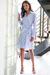 A model wearing the Finley Farrah dress, a tie front cotton voile wrap maxi dress with a blue and white stripe/