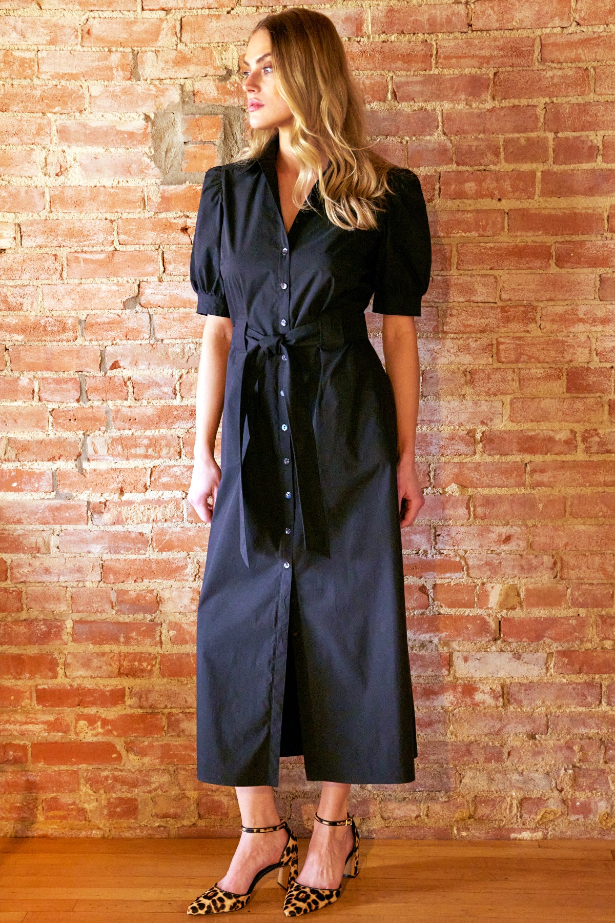 Model wearing the Finley Harper, a black tie front maxi shirt dress in weathercloth fabric.