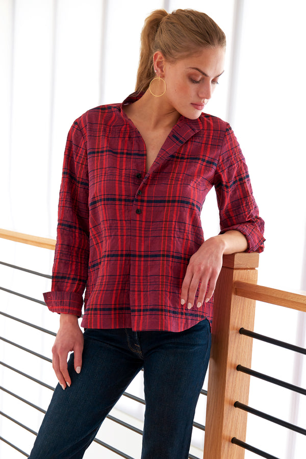 A model wearing the Finley Henri blouse, a purple and red plaid button down long sleeve women's blouse with a relaxed shape and a band collar.
