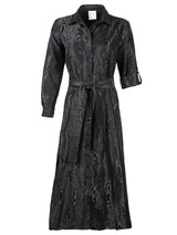 A frontal view of the Finley Laine dress, a tie front maxi dress with a spread collar, a self belt, and jacquard moire embroidery tonal accents.