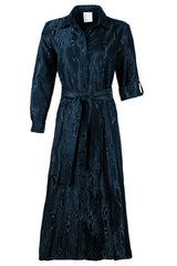 A front view of the Laine dress, a long maxi tie front dress in a teal moire jacquard design.