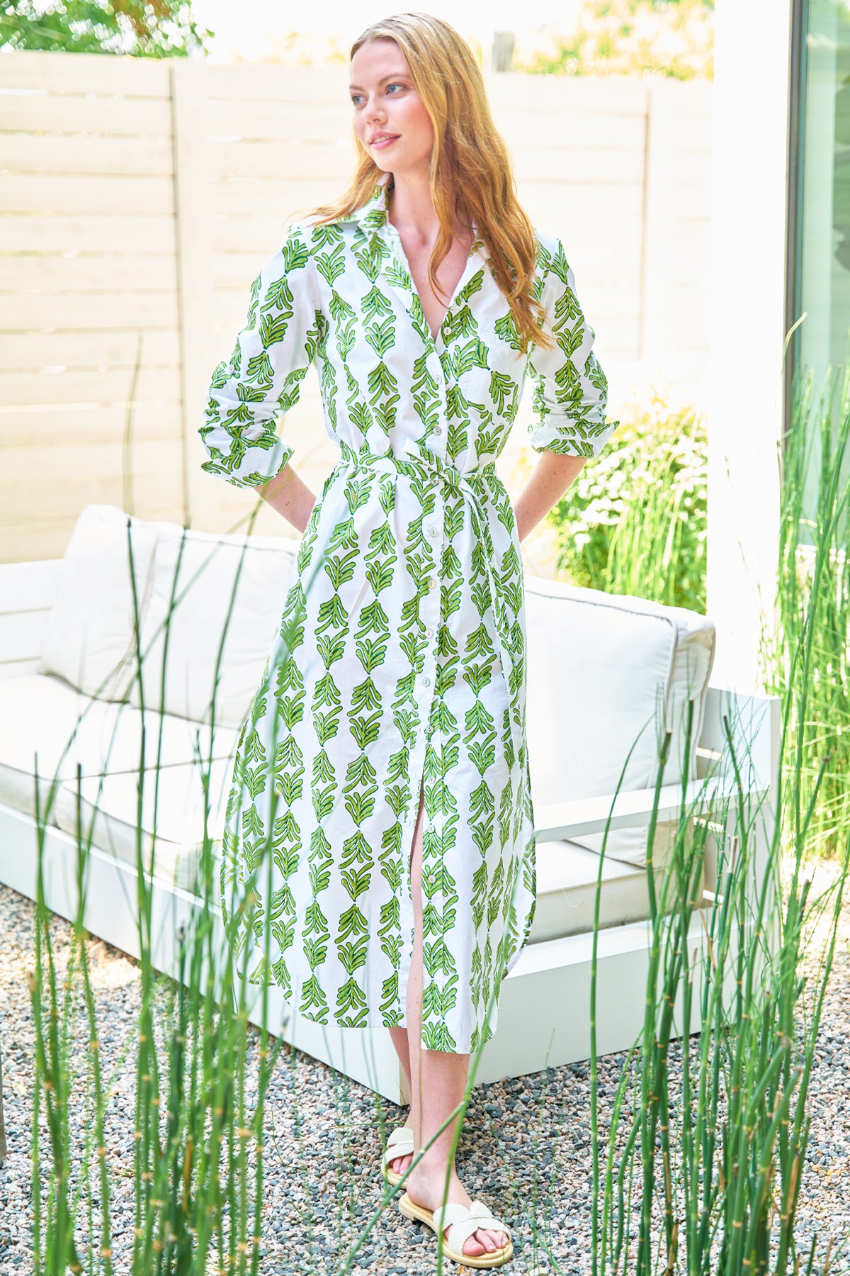 Model wears Finley Alex hand-blocked blue print midi shirtdress. Long sleeves, button front, waist tie, below the knee.