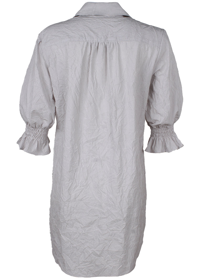 A rear view of the Finley Miller shirtdress, a pale green washed linen button down shirt dress with short puff sleeves. 