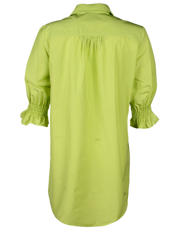 A rear view of the Finley Miller shirt dress, a neon lime green cotton/poly shirt dress with puff short sleeves, pockets, and a relaxed shape.