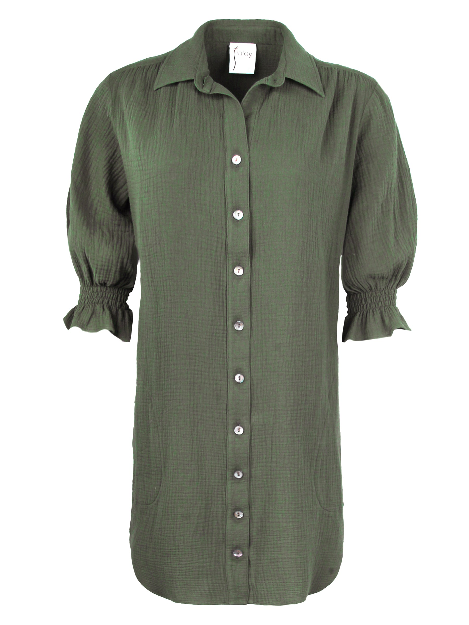 A front view of the Finley Miller shirt dress, a 100% cotton olive green shirt dress with a relaxed contour and elbow-length puff sleeves.
