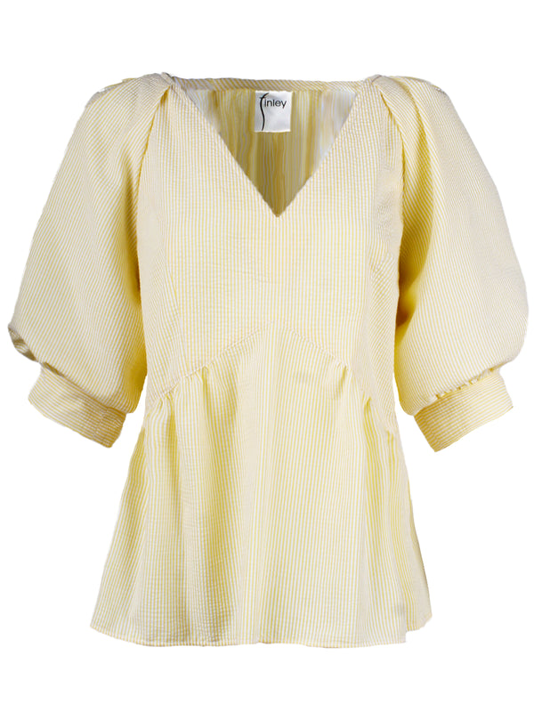 The Finley Prisha blouse, a yellow seersucker popover v-neck blouse with puff short sleeves and a flounce ruffle hem.