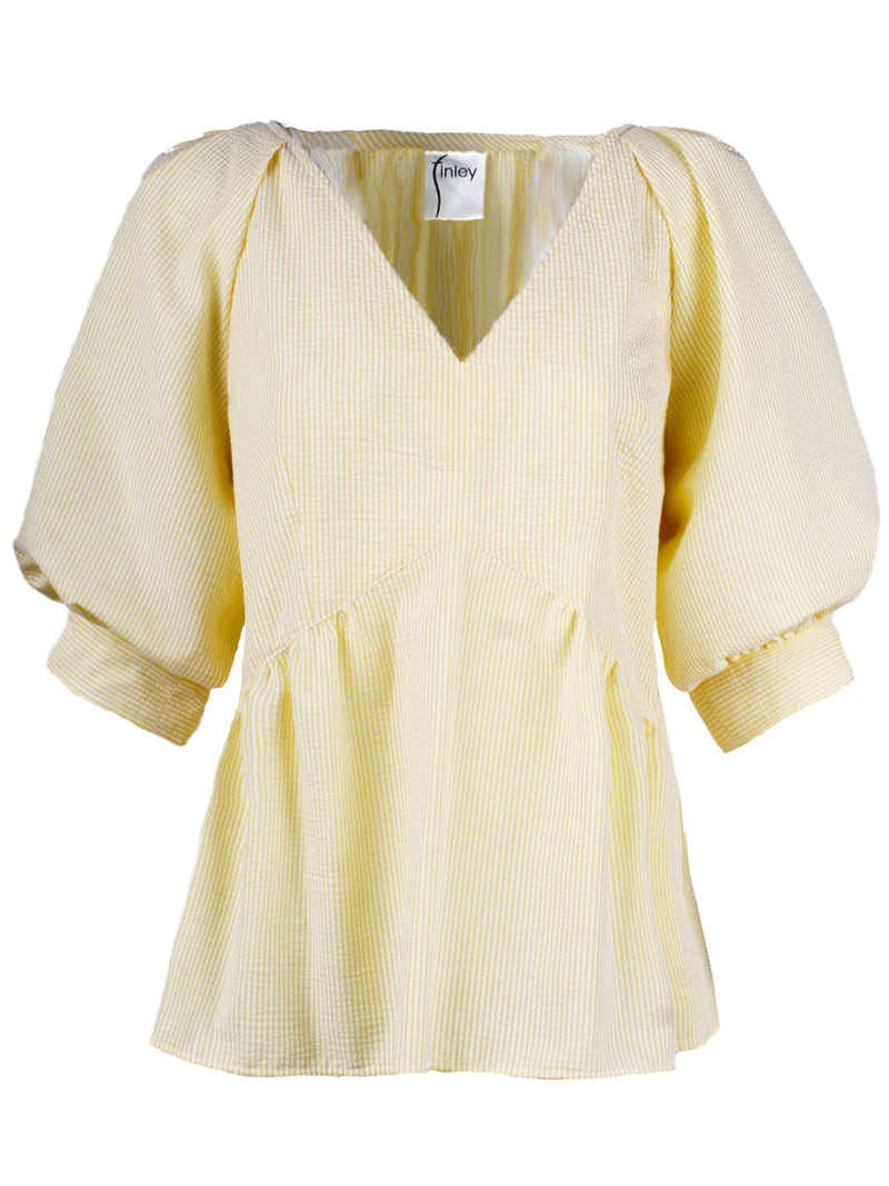 The Finley Prisha blouse, a yellow seersucker popover v-neck blouse with puff short sleeves and a flounce ruffle hem.