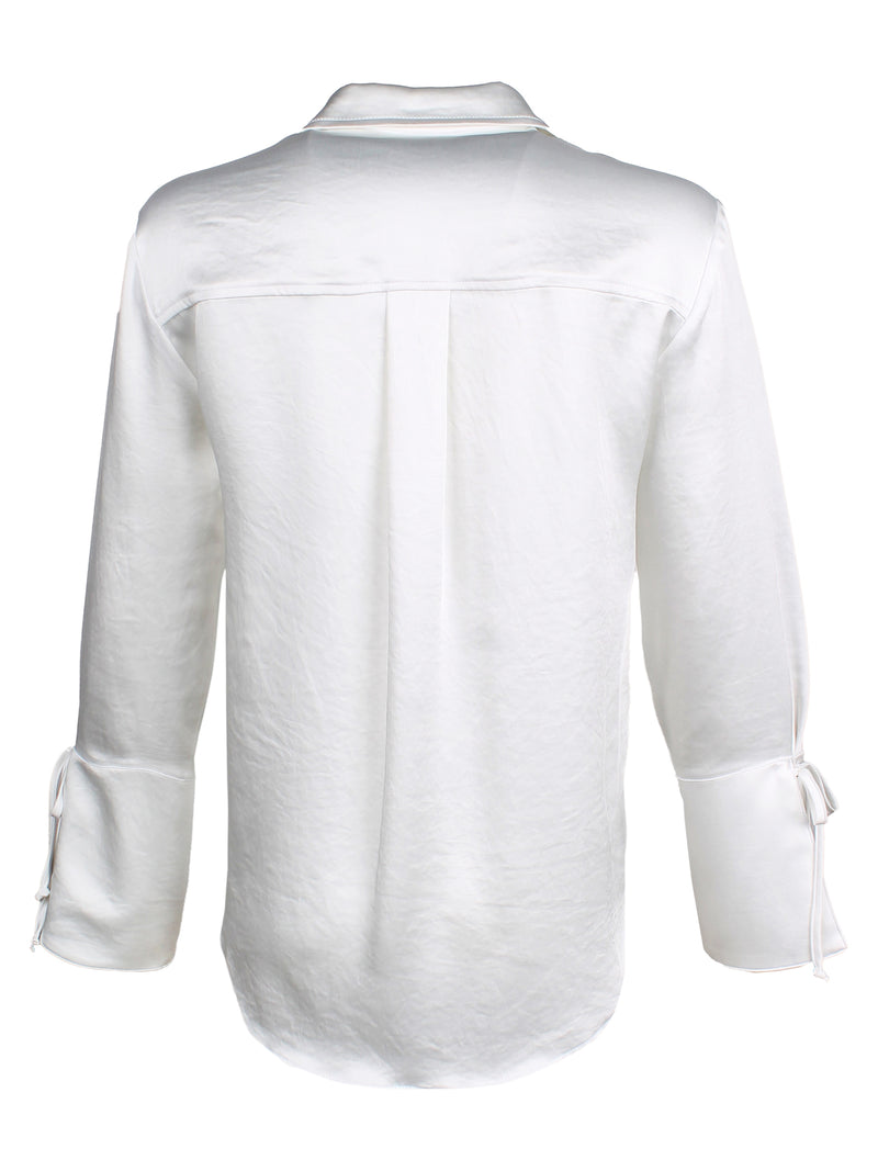 A rear view of the Finley Rachel blouse, a ivory white satin button down oversize women's blouse with cuff self-ties and a point collar.