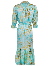 A rear view of the Finley Sienna dress, a cotton voile tie-front maxi dress with smocked cuffs and a tropical watercolor print.