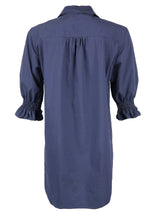 A rear view of the Miller dress, a button down navy designer shirtdress with a spread collar and elastic puff sleeve detail.