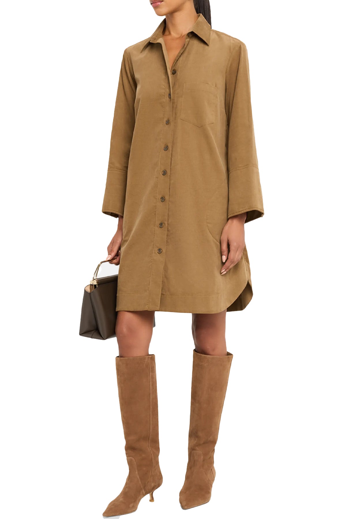 Woman wearing a brown dress and knee-high boots holding a handbag on a white background