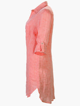 A  view of the Finley Alex shirtdress, a peach pink washed linen button-down midi shirt dress.