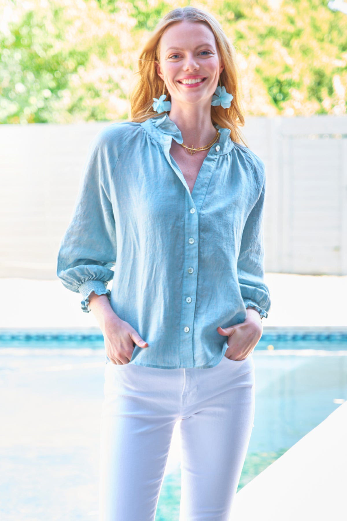 a model front view of the Finley Fiona blouse with a ruffle collar, puff sleeves, button-down front, and made of washed linen.
