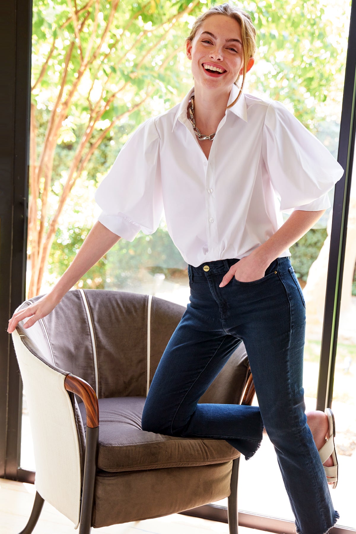 The Finley Bomba blouse, a casual white designer blouse with short puff sleeves and a relaxed fit.