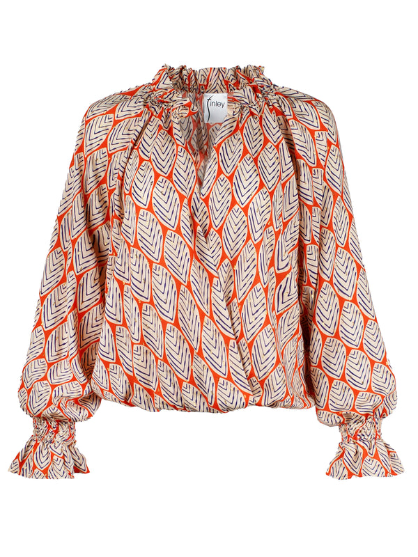 The Finley Brette blouse, an oversize popover puff sleeve v-blouse with ruffle trim and an orange and white leaf pattern.