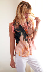 A model wearing the Finley Byrdee shirt, an orange-brown print cotton voile sleeveless ruffle blouse.
