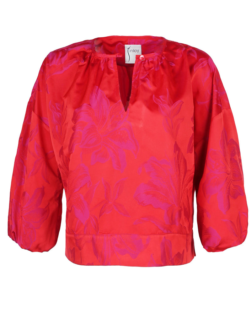 The Finley crew top, a pink and red polyester pullover blouse with a 3/4 sleeve and a pink and red floral jacquard pattern.