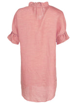 The Finley Crosby shirt dress, a washed linen peachy pink midi shirtdress with short sleeves and a ruffle collar detail.