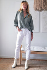 The Finley Fiona shirt, a washed hemp sage green chambray button down blouse with ruffle detailing on collar and sleeves.The Finley Fiona shirt, a washed hemp sage green chambray button down blouse with ruffle detailing on collar and sleeves - model frontal