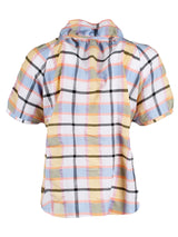 The Finley Frankie blouse, a blue & yellow plaid raglan sleeve v-neck camp shirt with ruffle trim detailing.