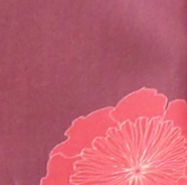 A close-up of a pink fabric surface with a stylized red flower graphic in the lower right corner.