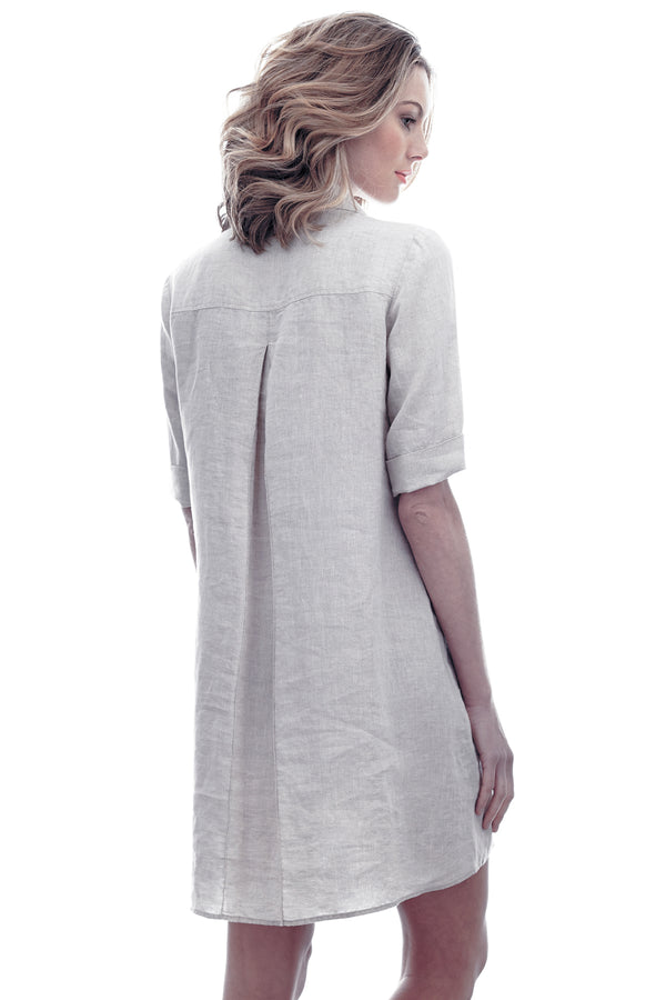 A model wearing Finley Marcia dress, a natural gray washed linen short-sleeve v-neck shirt dress.