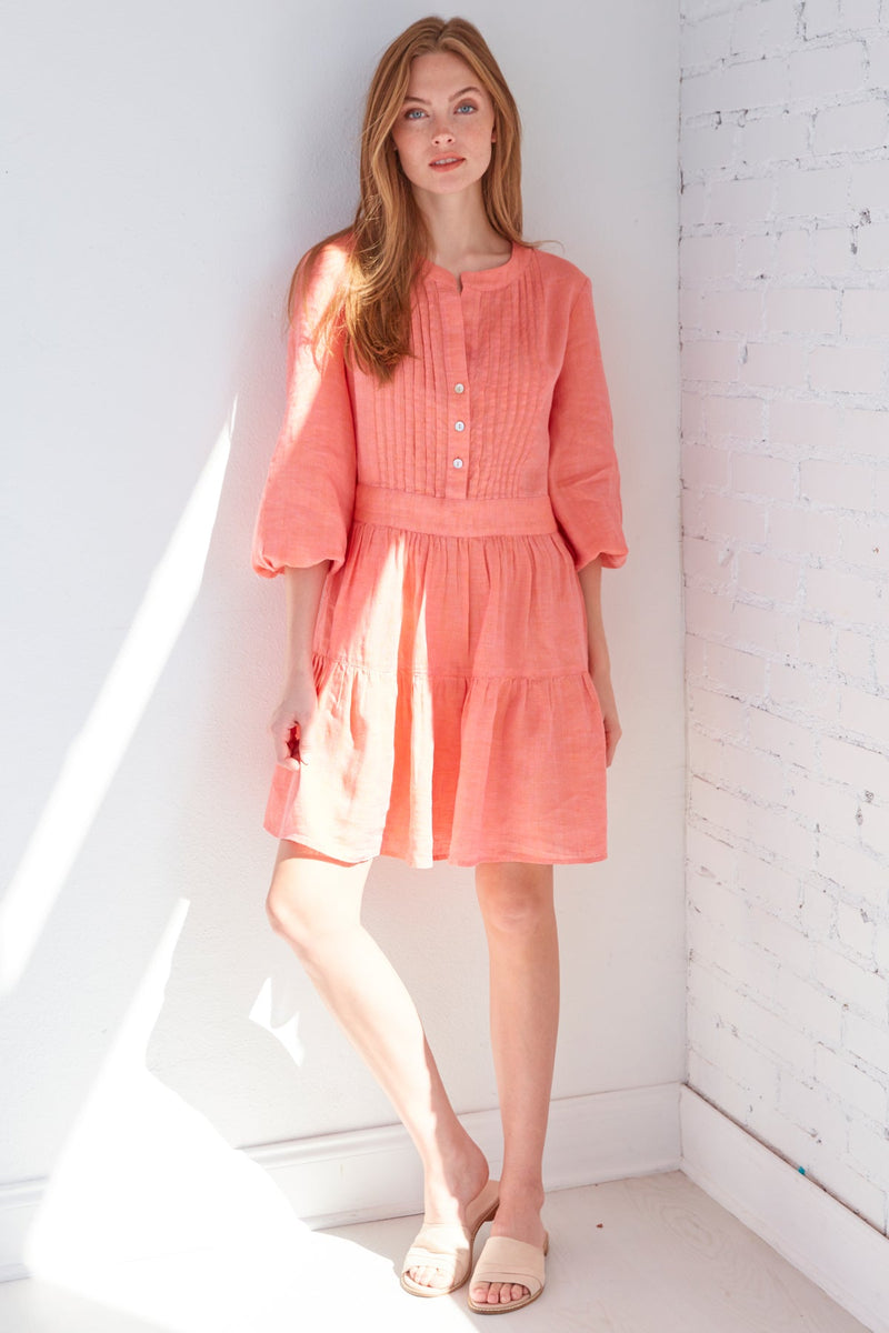 A model wearing the Finley Mia dress, a washed linen long-sleeve button dress with a relaxed fit and a dusty pink color.