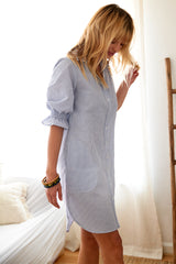 The Finley Miller dress, a yellow seersucker shirt dress with puff sleeves, a spread collar, and pockets.