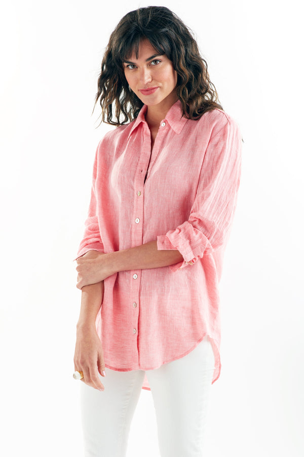A fashion model wearing the Finley Monica blouse, a washed linen button-down shirt with a relaxed fit and a coral pink color.