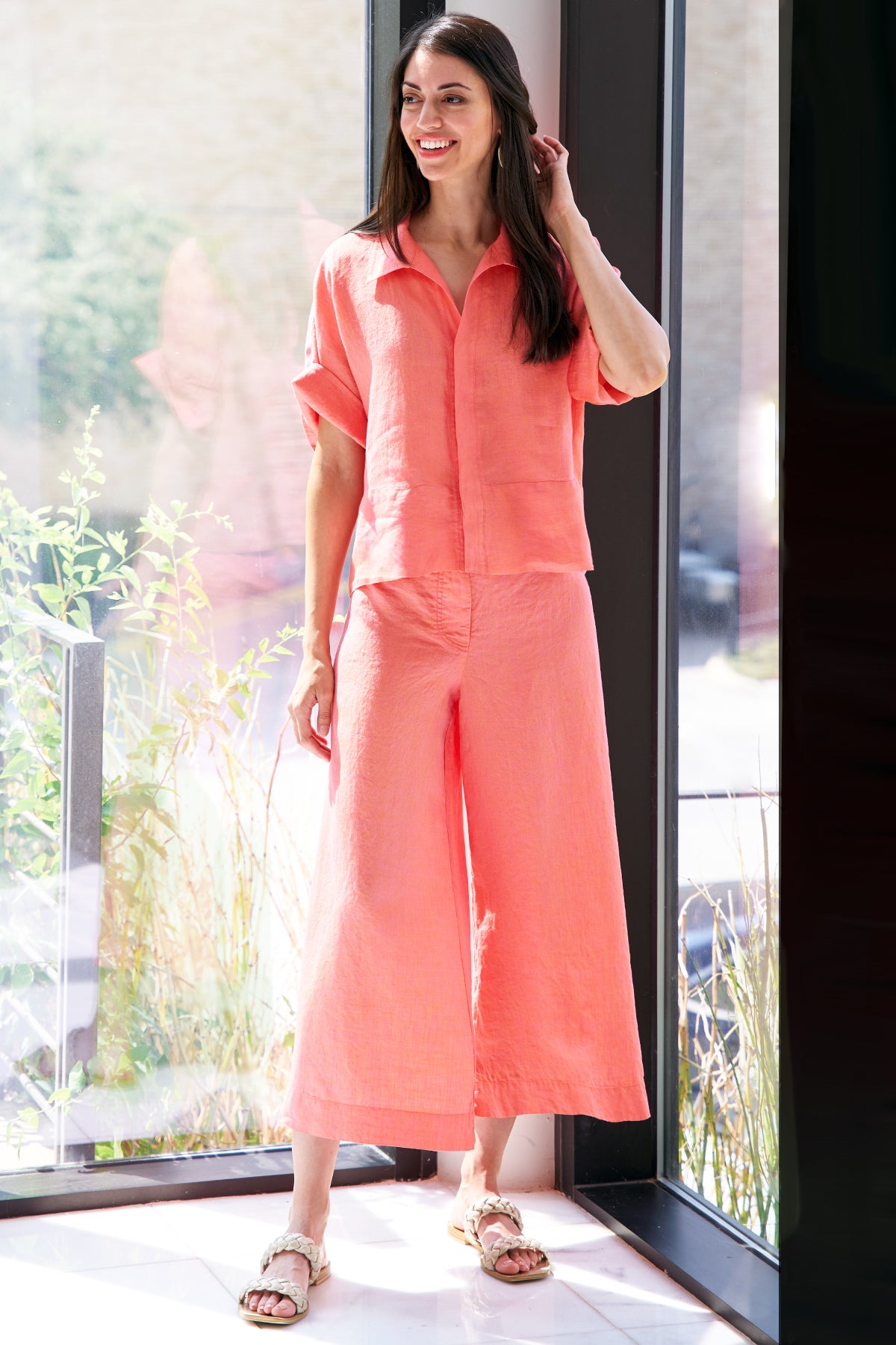 A model wearing the Finley Bennett blouse, a washed linen cropped blouse with drop shoulders and an oversize shape.