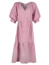 The Finley Paloma dress, a pink and white seersucker maxi dress with pleated blouson sleeves and a ruffle hem.
