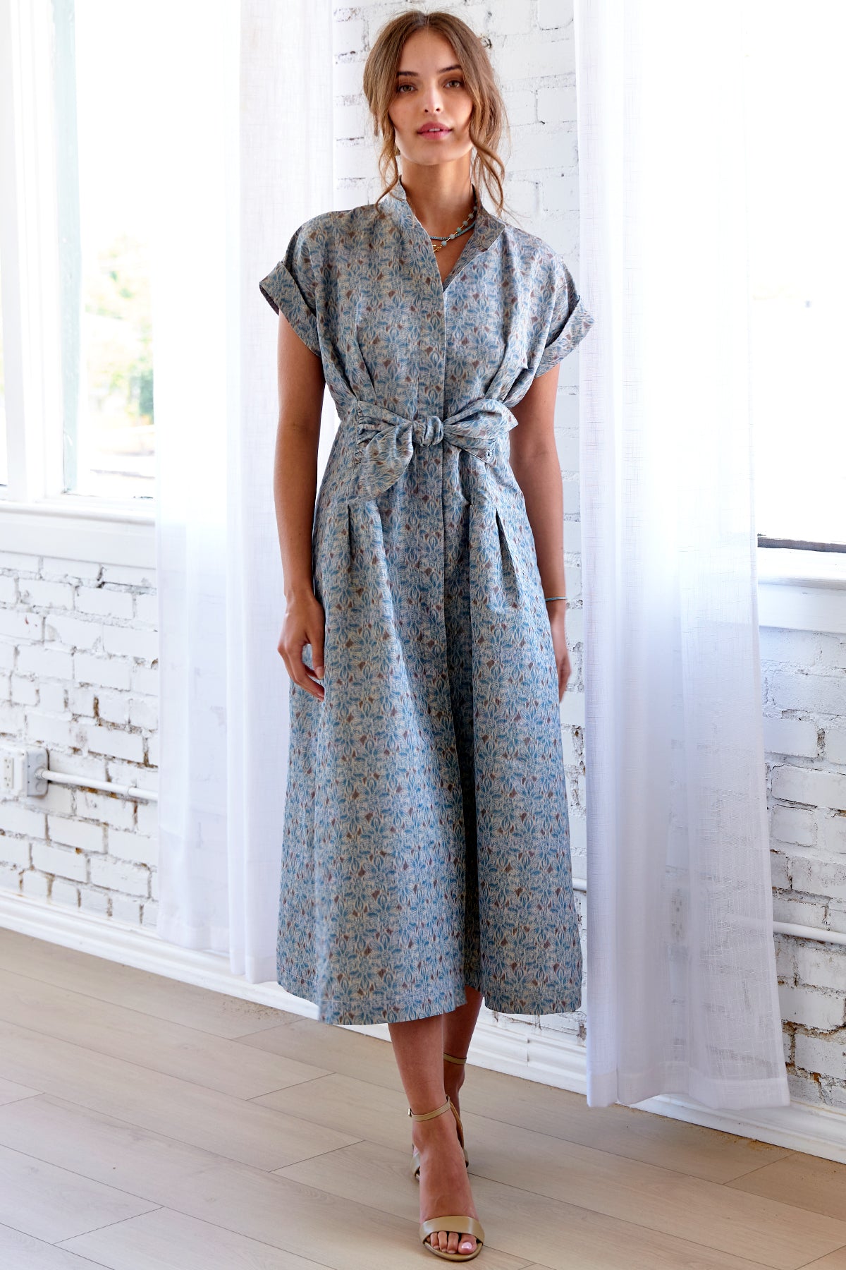 A model wearing the Rocky tie-front maxi dress in taffeta with short cap sleeves, A-line silhouette, and fit-and-flare design.

