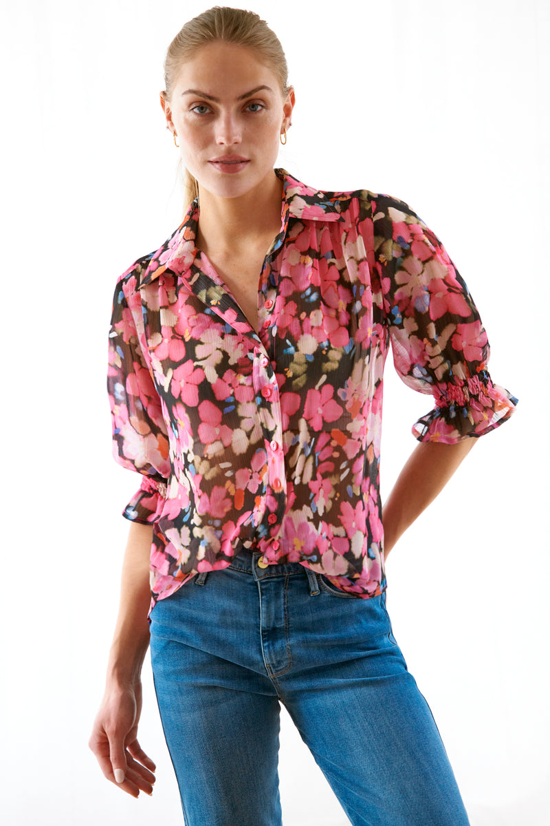 The Finley Sirena shirt, a popover ruffle women's blouse with ruffled short sleeves and a pink and black floral print.