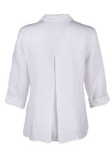 The Finley swing shirt, a white washed linen v-neck popover women's blouse with an inverted pleat.