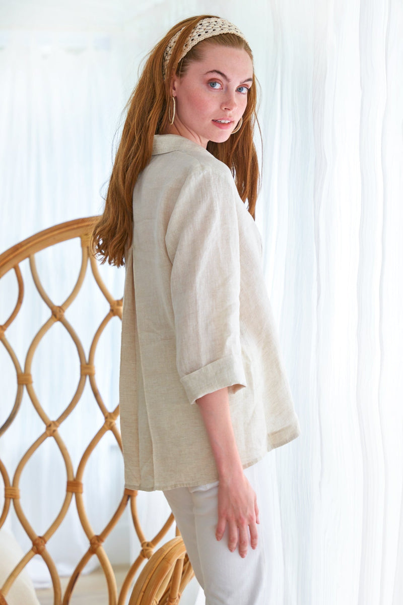 The Finley swing shirt, a white washed linen v-neck popover women's blouse with an inverted pleat.