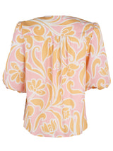 The Finley Tish top, a 100% cotton v-neck popover blouse with short puff sleeves and an orange floral pattern.