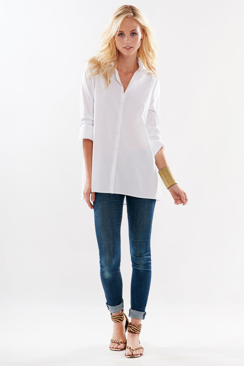 A fashion model wearing the Finley trapeze top, a black long-sleeve button-down blouse with a relaxed fit and an A-line shape.